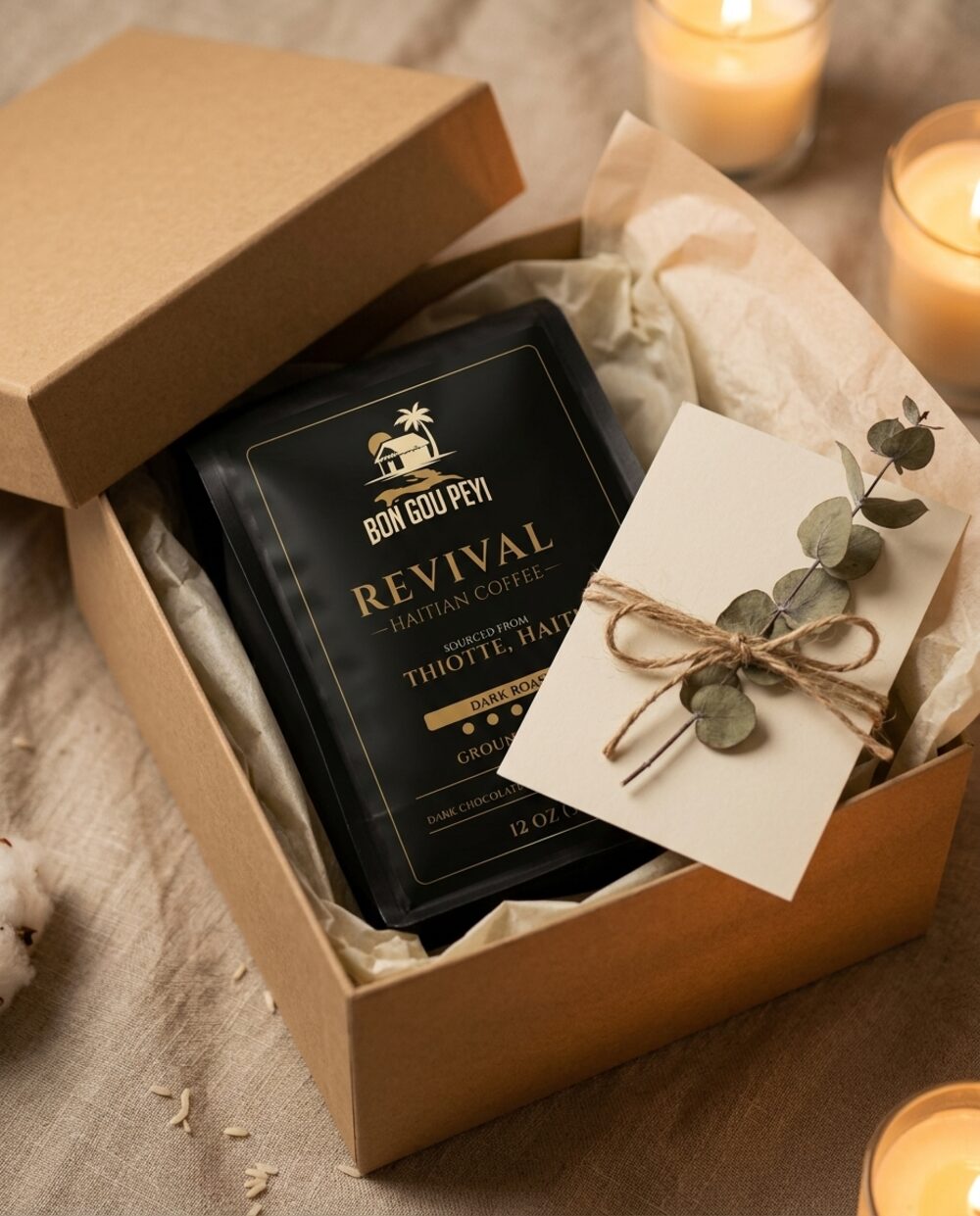 A Revival Haitian coffee bag nestled in a kraft gift box with a cream card, twine and eucalyptus
