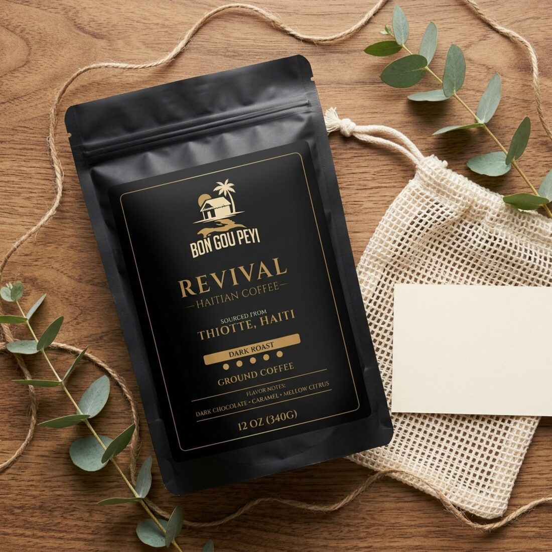 A Revival Haitian coffee bag styled with an ivory mesh favor pouch, a cream card and eucalyptus
