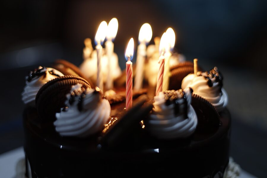 Cupcakes topped with lit birthday candles